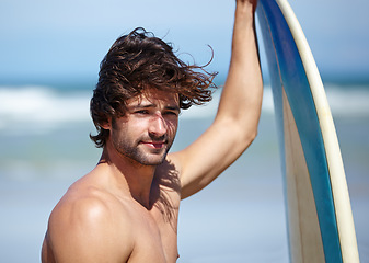 Image showing Beach face, surfboard and sports man thinking of holiday, vacation or Spain getaway for surf training, practice or outdoor wellness. Summer break, sunshine and relax surfer looking at nature view