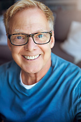 Image showing Portrait, mature or happy man in apartment with glasses or freedom on living room sofa to relax. House, face or senior person with smile, peace or wellness in home for a resting break in retirement