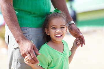 Image showing Portrait, smile and father with girl, holding hands and support with happiness, excited and care. Face, closeup and child with dad, outdoor and kid with joy, summer break and outside with sunshine