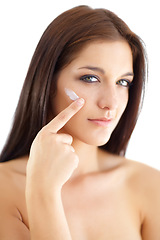 Image showing Portrait, woman and apply of moisturiser in studio in skincare cosmetic on white background. Model, person and lotion for anti-aging results, hydration or vitamin c in pigmentation or collagen boost