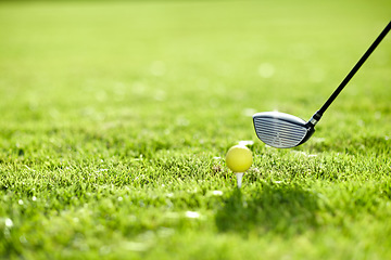 Image showing Golf, tee and ball with club on field by ready with swing to hit in hole on driving range in closeup. Sports, training and fitness with challenge for dedication, practice and skill for game in summer