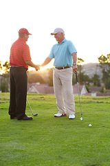 Image showing Golf, man and shaking hands with smile on course after game, match or training on field. Mature player, happy and enjoyment of competition handshake with friend for exercise, wellness or challenge