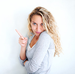 Image showing Woman, portrait and pointing finger playful or flirt fun, white wall background as mockup space. Female person, confident and goofy face emoji hand gesture or showing attention, joke humor in Canada