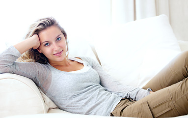 Image showing Woman, portrait and living room couch for lazy relax weekend, comfortable day off or cosy. Female person, face or tranquility solitude smile pose on apartment sofa for calm, positive mood in Canada