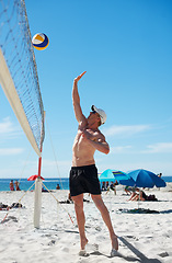 Image showing Volleyball, man and fitness at beach with ball serve, energy or freedom on blue sky background. Seaside, sports or male player with handball in nature for cardio, workout or athletic game performance