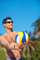 Image showing Volleyball, sports and happy fitness man at a beach with ball serve, energy or freedom on blue sky background. Smile, sports or male player with handball in nature for workout, game or performance