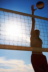 Image showing Volleyball, jump and man at beach with ball serve, energy or freedom on blue sky background. Fitness, sports or male player with handball in nature for cardio, workout or athletic game performance