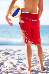 Image showing Beach sand, ocean or sports person with volley ball for outdoor game, competition or looking at water waves. Hands, legs and back of volleyball player fitness, training and watch nature sea view