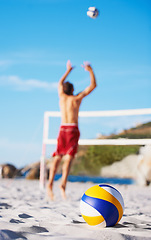 Image showing Sand, sports person and volleyball for beach game, competition or outdoor nature challenge, practice or fitness. Island floor, workout and athlete jump for volley ball in match, exercise or contest