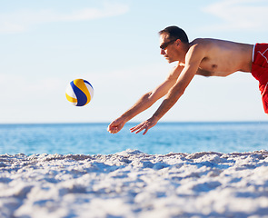 Image showing Beach, sports man and jump for volleyball in game, competition or outdoor nature challenge, practice or fitness. Blue sky, ocean sea sand or athlete leap for volley ball in match, exercise or contest