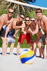 Image showing Beach volleyball, sports ball and team thumbs up for yes, competition or game collaboration agreement. Emoji like sign, group opinion vote or athlete for fitness, exercise or training on nature sand