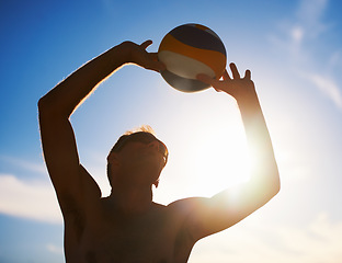 Image showing Fitness, volleyball and man in nature for travel, energy and freedom on blue sky background. Handball, exercise and male player with seaside sport, fun or game, challenge or outdoor match performance