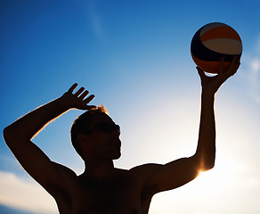 Image showing Volleyball, training and fitness man with ball serve, energy or freedom on blue sky background. Seaside, sport or male player with handball in nature for cardio, workout or athletic game performance