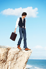 Image showing Business man, summer and standing on a cliff by the beach for adrenaline, adventure or a break in nature. Thinking, walking and a worker or person on the edge of a rock or mountain at the ocean