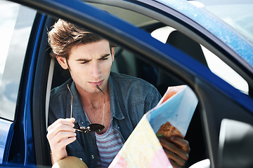 Image showing Reading, map and man in a car for travel, journey and lost driver on a road trip and adventure. Check, location and person with transportation to explore the world, countryside or direction to city