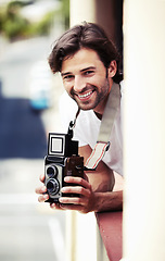 Image showing Portrait, man and photographer with a camera, city and smile with vacation, travel and tourism. Face, person and guy with equipment, summer holiday and Italy with photograph, capture moment and relax