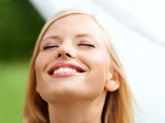 Image showing Happy, freedom and face of woman with fabric closeup in garden with clean linen, laundry or sheet in the wind. Natural, beauty and girl with a white cloth and happiness in house backyard or nature