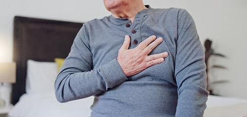 Image showing Hands, chest pain and closeup of senior man in bedroom with injury, hurt or accident at nursing home. Sick, ill and zoom of elderly male person in retirement with asthma or heart attack at house.