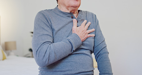 Image showing Hands, chest pain and closeup of elderly man in bedroom with injury, hurt or accident at nursing home. Sick, ill and zoom of senior male person in retirement with asthma or heart attack at house.