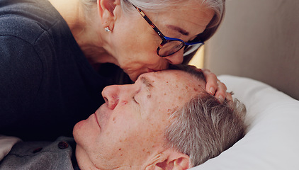 Image showing Senior woman kissing her husband on forehead with love, care and marriage in bed at home. Sick, recovery and elderly couple in retirement with illness in bedroom of hospice, nursing center or house.