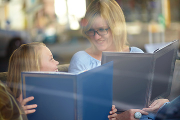 Image showing Reading, books and mother with child in library with smile, learning and relax with study knowledge. Storytelling, happy mom and girl in bookstore together with story, fantasy and education in window