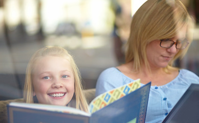 Image showing Reading, portrait and mother with child in bookshop with smile, learning and relax in knowledge. Storytelling, happy mom and girl in library together with story, fantasy books and education in window