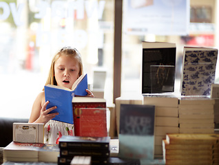 Image showing Reading, books and child in bookshop with shock, learning and surprise with knowledge in shop. Storytelling, girl in bookstore with story, fantasy novel stack and education with imagination in store