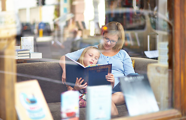 Image showing Reading, books and mother with child in bookshop window with smile, learning and relax with knowledge. Storytelling, happy mom and girl in library together with story, fantasy and education in window