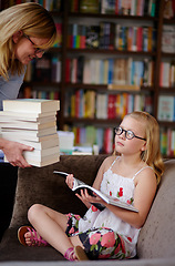 Image showing Reading, books and woman with child in library with stack, learning and relax with study knowledge. Storytelling, happy mom and girl in bookstore together with story, fantasy and education on couch.