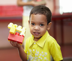 Image showing Boy, portrait and building blocks in classroom for development, scholarship and games at kindergarten. Happy student child, plastic toys and smile for education at academy, school or growth in class