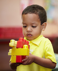 Image showing Boy, education and building blocks in classroom for thinking, scholarship or development at kindergarten. Preschool student, kid and plastic toys for play, idea or learning problem solving at academy