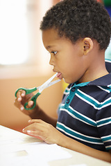 Image showing Boy, scissor danger and learning in classroom for blade by tongue for development, growth or preschool scholarship. African kid, sharp object and mouth with paper, injury or education at kindergarten