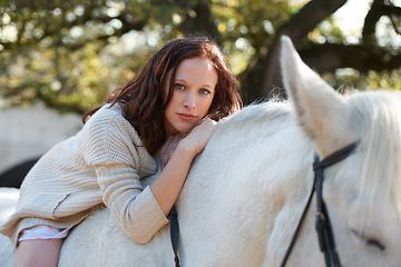 Image showing Nature, portrait and woman laying on her horse on an outdoor farm for sports racing. Smile, happy and young person from Canada with her equestrian animal or pet in countryside ranch for adventure.