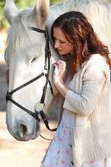 Image showing Adventure, love and young woman with her horse on an outdoor farm for sports racing. Smile, training and confident female person from Canada with her equestrian animal or pet in countryside ranch.