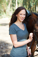 Image showing Happy, nature and portrait for woman with her horse on an outdoor farm for sports racing. Smile, training and confident young female person from Canada with her mammal animal or pet in countryside.