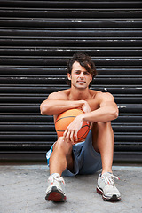 Image showing Basketball player, portrait or sports man relax, break and wellness after workout performance, exercise or practice. Active, athlete or urban person rest after fitness, shirtless and sitting on floor