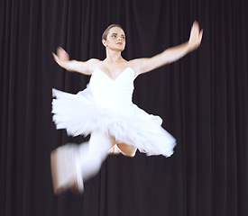 Image showing Ballet woman dancer, dancing does dance jump in air during creative stage performance. Professional ballerina practicing training balance, fitness and energy for a theatre production or opera concert