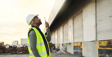 Image showing Construction worker, engineer black man manager on site inspection for building, warehouse or industrial project development. Outdoor contractor businessman and walkie talkie communication management