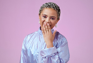 Image showing Portrait of a woman in purple with her hand over her mouth, expression of surprise. Mockup for makeup, fashion and wow emotion on face. Young black woman isolated on pink background in studio