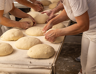 Image showing Bakers forming bread loaves