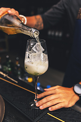 Image showing Barman is preparing a cocktail