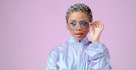 Image showing Fashion, beauty and mockup with a black woman in glasses on a pink background in studio for advertising and marketing. Style, edgy and trendy with an attractive female posing with cool sunglasses