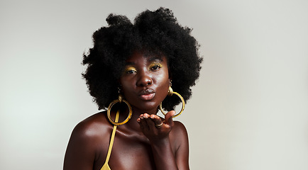 Image showing Black woman fashion model blow kiss for beauty, makeup and African empowerment in skincare and afro hair. Headshot portrait of creative young Nigeria girl or happy black person in studio background