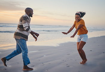 Image showing Love, freedom and couple at a beach at sunset, laughing and having fun on summer vacation in nature. Relax, sea and black woman and man being playful and joking, enjoying sand and ocean walk together