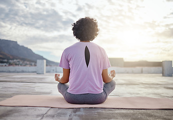 Image showing Yoga, back view and woman in meditation on roof training to meditate body and spiritual mind in Cape Town city. Fitness, wellness and zen girl in peaceful lotus pose for a relaxing exercise outdoors