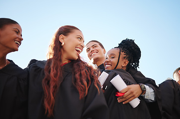 Image showing Students, hug and graduation certificate success in ceremony celebration on school, university or college campus. Low angle, friends diversity or graduate diploma in education learning or scholarship