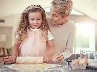 Image showing Family, learning and girl baking with grandmother in a kitchen, bonding while prepare cookies together. Teaching, independence and child development by senior woman showing child how to bake snack