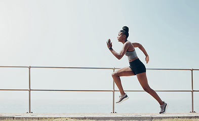 Image showing Sports, running and speed with black woman training in beach park for workout, wellness and health. Motivation, fitness and training for marathon with runner in the morning for summer, fast or energy