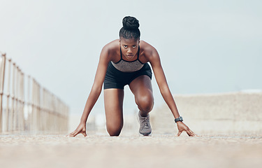 Image showing Fitness, runner and woman start running workout along beach, cardio and speed training. Sports, exercise and portrait of black woman prepare for marathon with morning run, serious, focus and intense