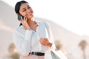 Image showing Shopping bag, phone call and woman talking to customer service for client communication, fashion or online review on 5g network. Wealth, luxury and retail girl in city on smartphone for ecommerce faq